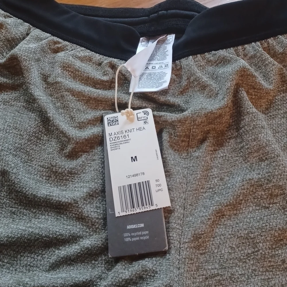 NWT   Adidas knit Grey shorts. Black waist band, white stripes. Size medium.